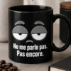 Mug minimaliste avec yeux à moitié fermés et slogan Ne me parle pas. Pas encore. en gris sur fond blanc