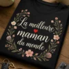 T-shirt femme à fleurs avec le texte La meilleure maman du monde, petit cœur rouge et illustration florale délicate sur fond sombre.